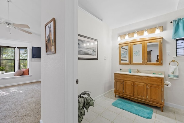 bathroom with ceiling fan, vanity, baseboards, and tile patterned flooring