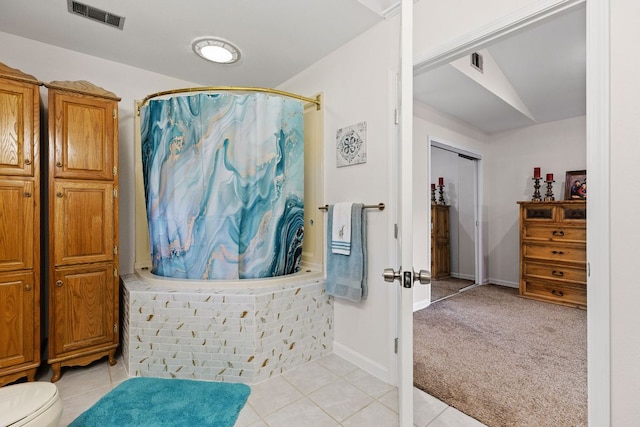 bathroom with tile patterned flooring, curtained shower, vaulted ceiling, toilet, and baseboards
