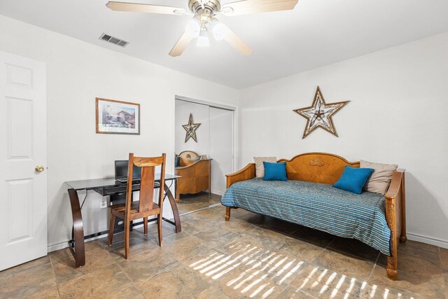 969 N State Highway 95, Bastrop, TX 78602 - bedroom with stone finish flooring, an office area, a closet, and a ceiling fan