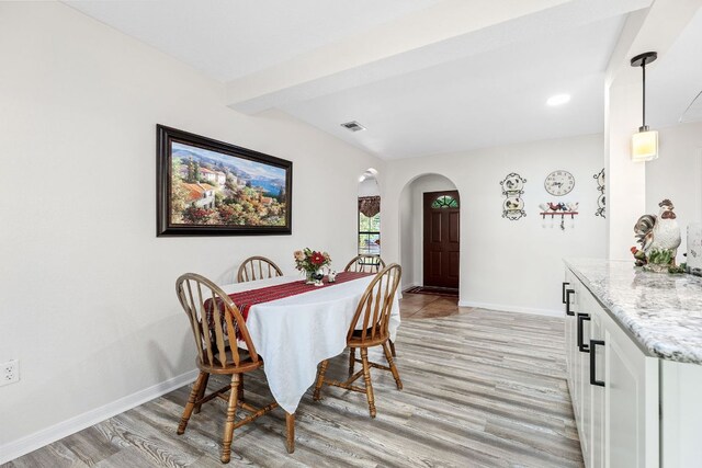 969 N State Highway 95, Bastrop, TX 78602 - dining room featuring arched walkways, light wood finished floors, and beam ceiling
