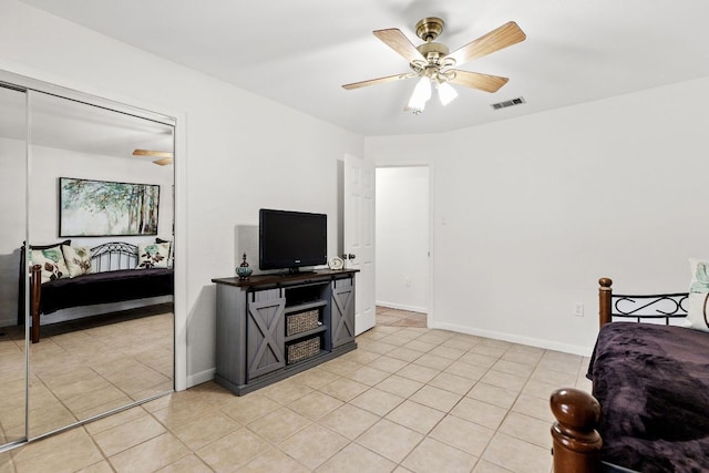 bedroom featuring light tile patterned floors, ceiling fan, and baseboards