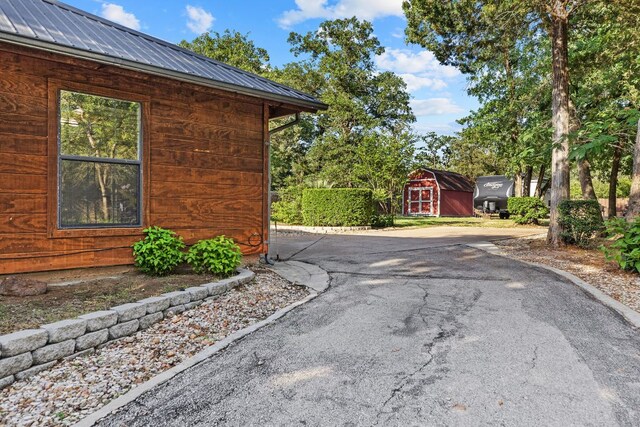969 N State Highway 95, Bastrop, TX 78602 - view of side of home featuring a storage shed and a metal roof