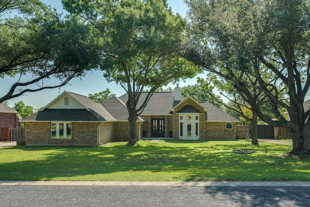 1305 Quail Ravine, Round Rock, TX 78664 - view of front of property with french doors, brick siding, a chimney, and roof with shingles