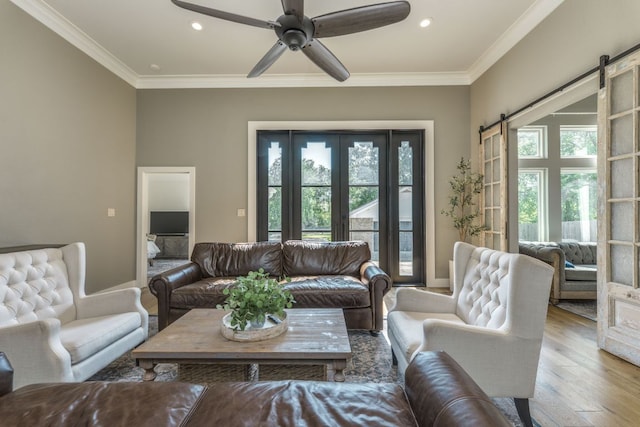 1305 Quail Ravine, Round Rock, TX 78664 - living room featuring a barn door, recessed lighting, ornamental molding, a ceiling fan, and wood finished floors