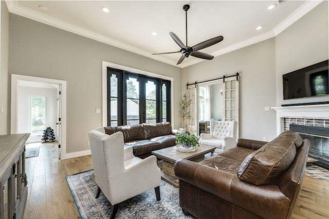 1305 Quail Ravine, Round Rock, TX 78664 - living area with crown molding, plenty of natural light, a ceiling fan, wood finished floors, and recessed lighting