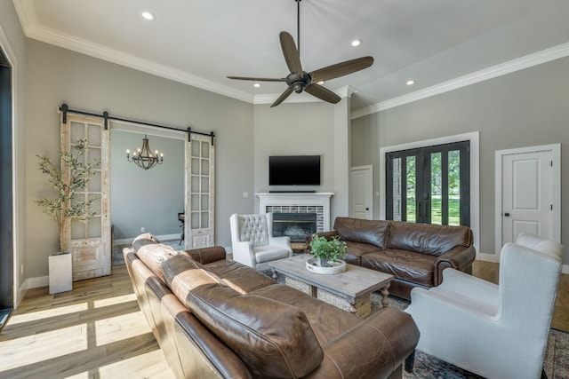 1305 Quail Ravine, Round Rock, TX 78664 - living room with a barn door, light wood finished floors, recessed lighting, ornamental molding, and ceiling fan