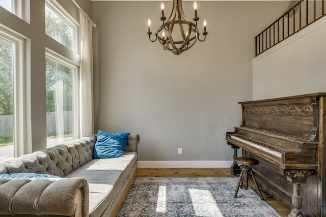 1305 Quail Ravine, Round Rock, TX 78664 - living area with a chandelier, wood finished floors, and baseboards