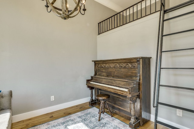 1305 Quail Ravine, Round Rock, TX 78664 - living area with a chandelier, baseboards, and wood finished floors