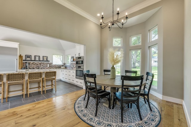 1305 Quail Ravine, Round Rock, TX 78664 - dining space with ornamental molding, a high ceiling, plenty of natural light, baseboards, and a chandelier