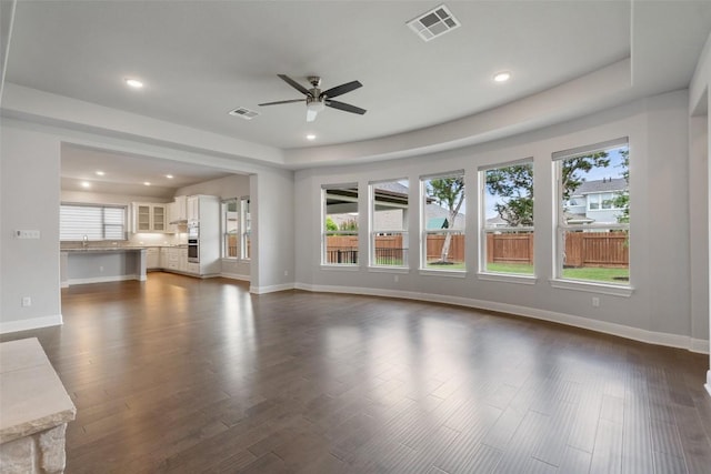 unfurnished living room featuring a ceiling fan, plenty of natural light, recessed lighting, and baseboards