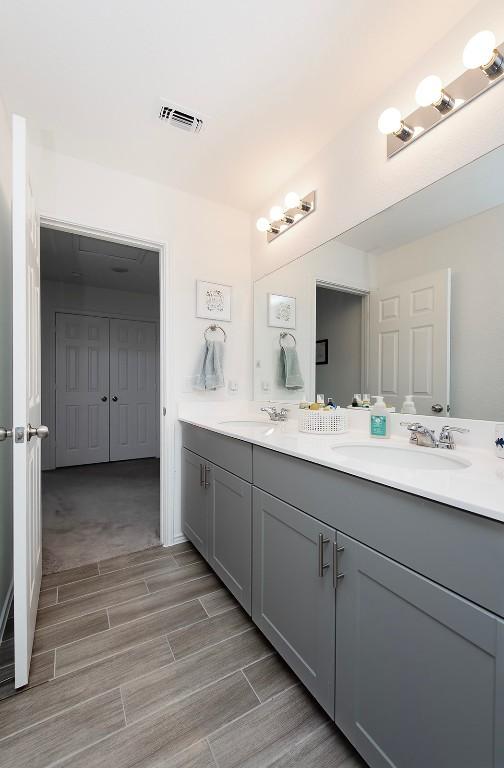 500 Pickrell Loop, Liberty Hill, TX 78642 - bathroom with wood tiled floors and double vanity
