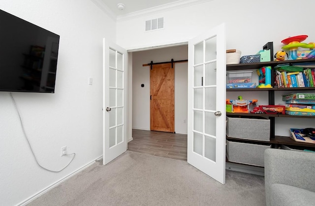 500 Pickrell Loop, Liberty Hill, TX 78642 - bedroom featuring french doors, ornamental molding, carpet flooring, a barn door, and baseboards
