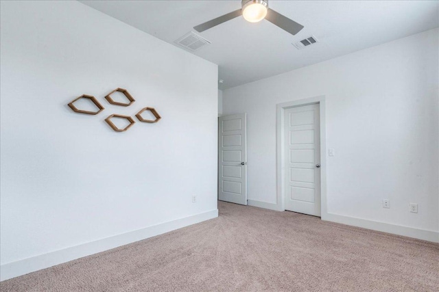 unfurnished room with light carpet, ceiling fan, and baseboards