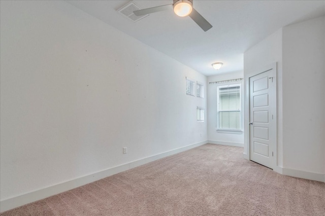 unfurnished bedroom with light colored carpet, baseboards, and ceiling fan