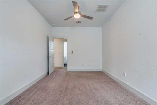 unfurnished room featuring light carpet, ceiling fan, and baseboards