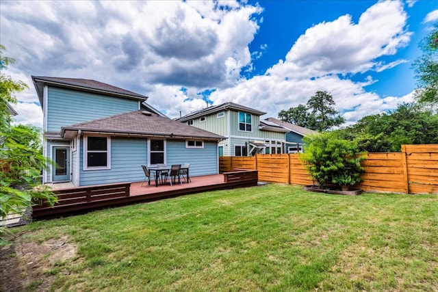 rear view of house featuring a wooden deck