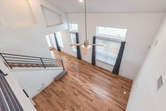 stairway featuring wood finished floors and a ceiling fan