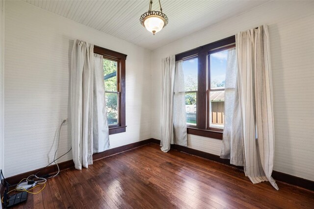 117 N Main St, Paige, TX 78659 - spare room with baseboards and dark wood-style flooring