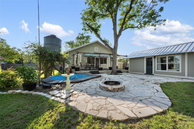 117 N Main St, Paige, TX 78659 - back of house with a fire pit, a patio area, and a deck