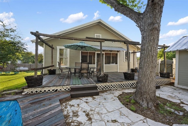 117 N Main St, Paige, TX 78659 - rear view of house featuring a deck, outdoor dining area, and a patio area
