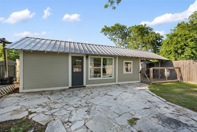 117 N Main St, Paige, TX 78659 - rear view of house with a patio area, fence, and metal roof