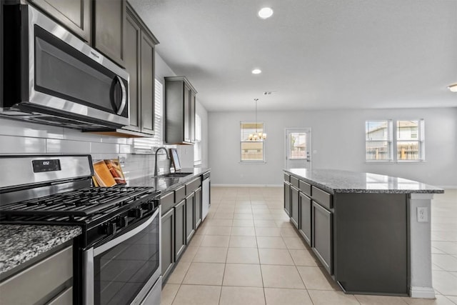 520 Betty Ann Way, Leander, TX 78641 - kitchen with appliances with stainless steel finishes, a sink, a center island, plenty of natural light, and recessed lighting