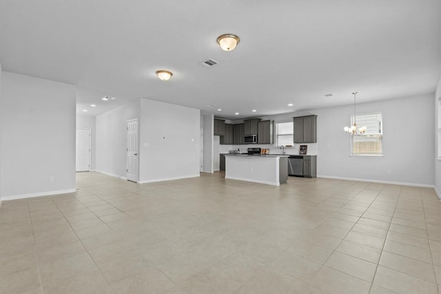 520 Betty Ann Way, Leander, TX 78641 - unfurnished living room featuring a chandelier, a sink, recessed lighting, light tile patterned flooring, and baseboards