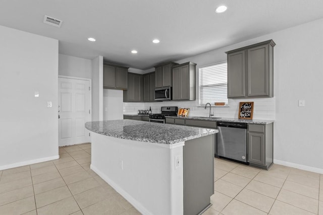 520 Betty Ann Way, Leander, TX 78641 - kitchen with stainless steel appliances, a sink, a center island, decorative backsplash, and recessed lighting