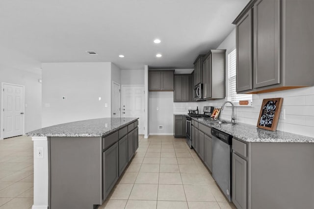 520 Betty Ann Way, Leander, TX 78641 - kitchen featuring stainless steel appliances, a sink, light tile patterned floors, a center island, and recessed lighting