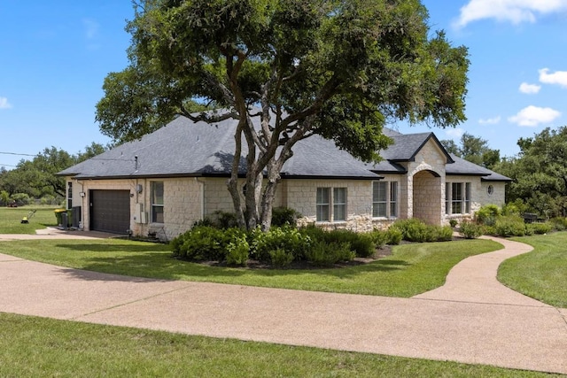 420 Oak Forest Dr, Buda, TX 78610 - french country inspired facade featuring stone siding, an attached garage, a front lawn, and driveway