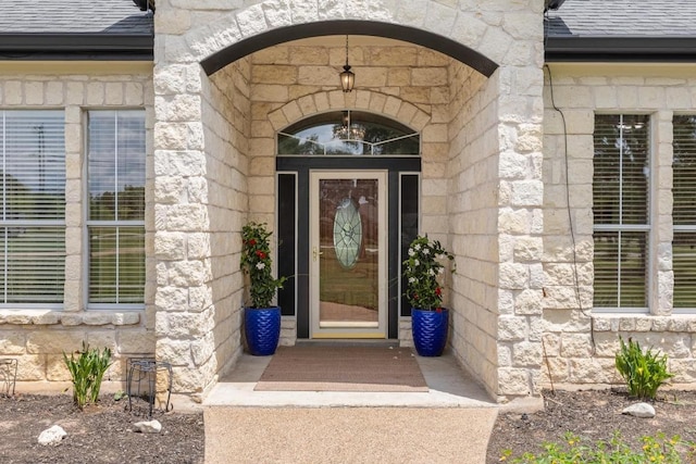 420 Oak Forest Dr, Buda, TX 78610 - view of exterior entry featuring roof with shingles and stone siding