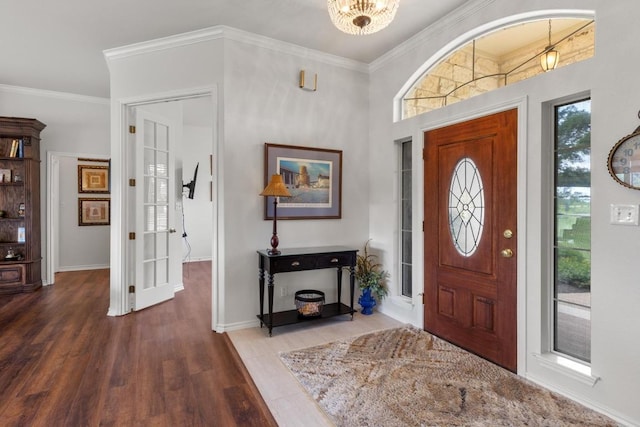 420 Oak Forest Dr, Buda, TX 78610 - foyer featuring wood finished floors, crown molding, baseboards, and a chandelier