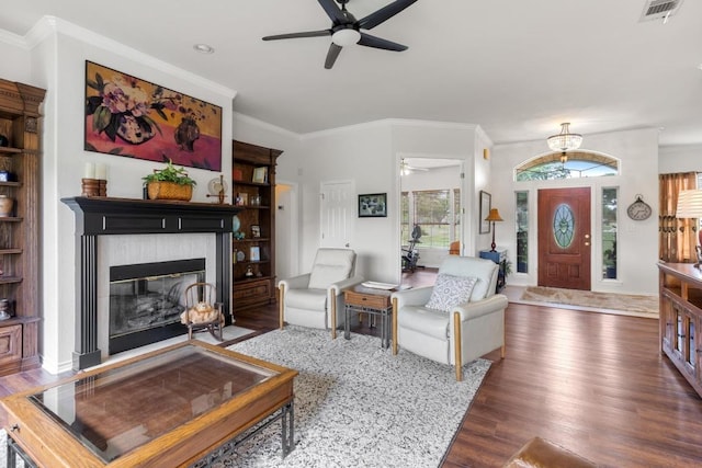 420 Oak Forest Dr, Buda, TX 78610 - living area with a ceiling fan, wood finished floors, a fireplace with flush hearth, ornamental molding, and recessed lighting