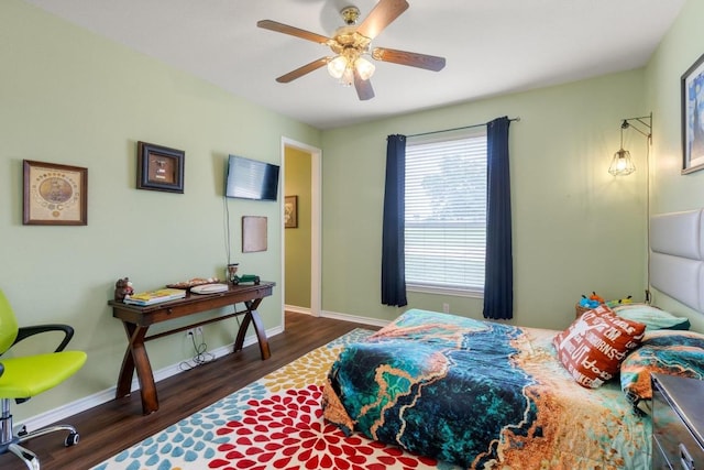 420 Oak Forest Dr, Buda, TX 78610 - bedroom with wood finished floors, baseboards, and ceiling fan