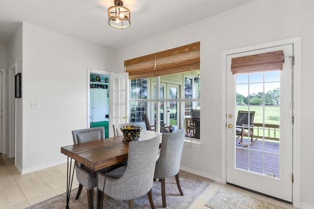 420 Oak Forest Dr, Buda, TX 78610 - dining space with light tile patterned floors and baseboards