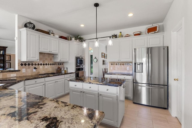 420 Oak Forest Dr, Buda, TX 78610 - kitchen with stainless steel appliances, tasteful backsplash, white cabinets, dark stone counters, and recessed lighting