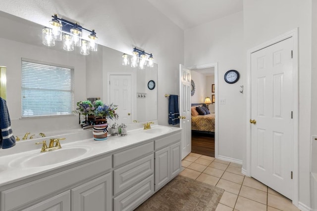 420 Oak Forest Dr, Buda, TX 78610 - ensuite bathroom featuring tile patterned flooring and double vanity