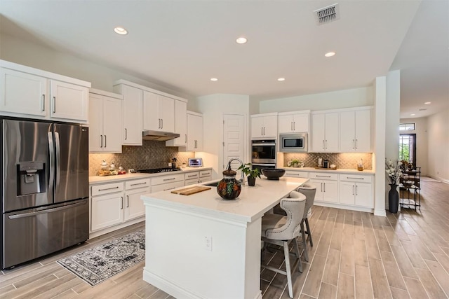25727 Madison Rnch, San Antonio, TX 78255 - kitchen featuring appliances with stainless steel finishes, a sink, white cabinetry, backsplash, and recessed lighting