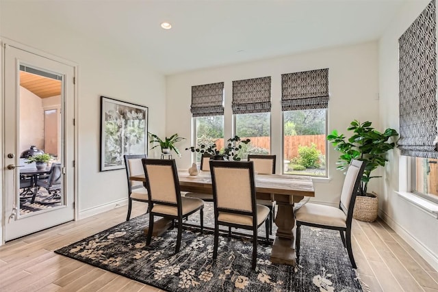 dining area with light wood-style flooring, baseboards, and recessed lighting