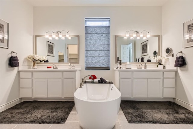 full bath with a soaking tub, tile patterned floors, and two vanities