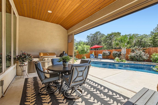 view of patio with a fenced backyard, grilling area, and outdoor dining space
