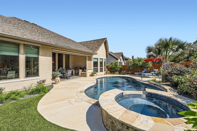 view of pool with a patio area, a fenced backyard, and a pool with connected hot tub