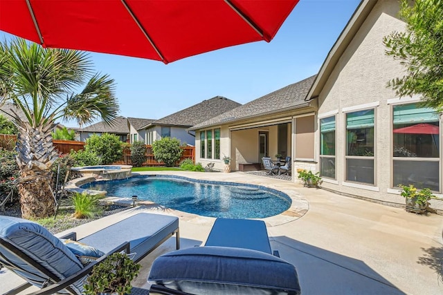 view of swimming pool featuring a fenced backyard, a patio area, and a pool with connected hot tub