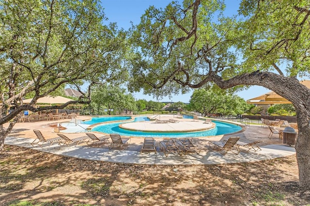 community pool with a patio area
