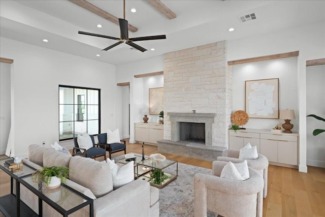 1754 County Road 146th Rd, Georgetown, TX 78633 - living area featuring light wood-type flooring, recessed lighting, a ceiling fan, a stone fireplace, and beamed ceiling