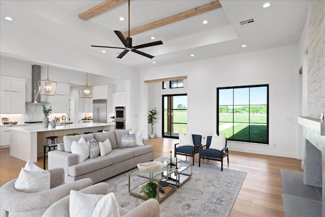 1754 County Road 146th Rd, Georgetown, TX 78633 - living area featuring a high ceiling, recessed lighting, light wood-style floors, a fireplace, and beamed ceiling