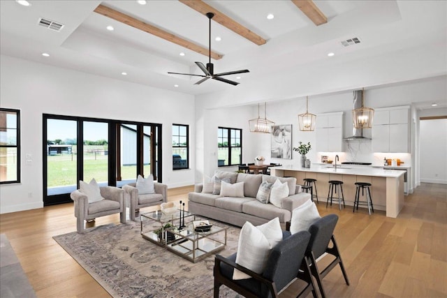 1754 County Road 146th Rd, Georgetown, TX 78633 - living room featuring light wood-type flooring, recessed lighting, healthy amount of natural light, beam ceiling, and ceiling fan