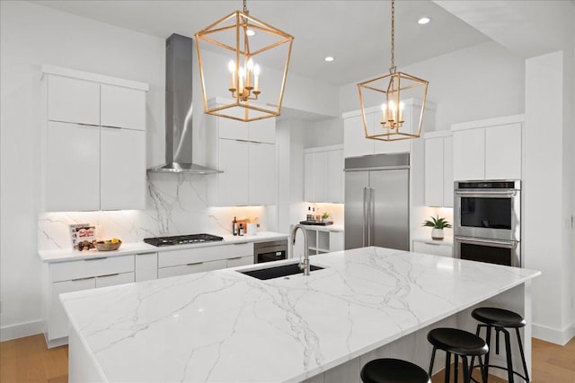 1754 County Road 146th Rd, Georgetown, TX 78633 - kitchen featuring wall chimney exhaust hood, stainless steel appliances, modern cabinets, a chandelier, and recessed lighting