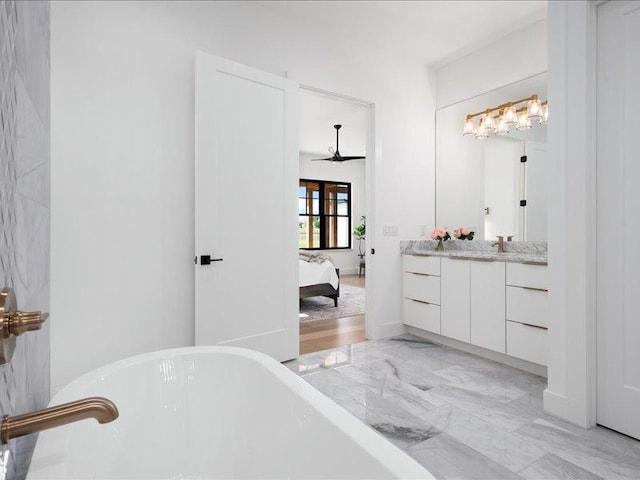1754 County Road 146th Rd, Georgetown, TX 78633 - ensuite bathroom featuring a soaking tub, vanity, ceiling fan, and marble finish flooring
