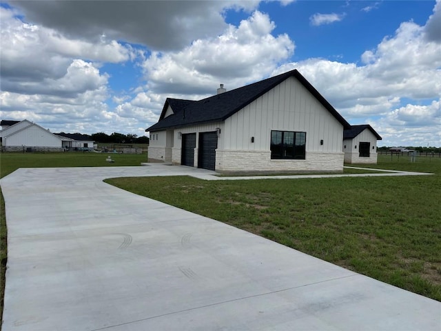 1754 County Road 146th Rd, Georgetown, TX 78633 - view of side of property featuring board and batten siding, a yard, a garage, driveway, and stone siding